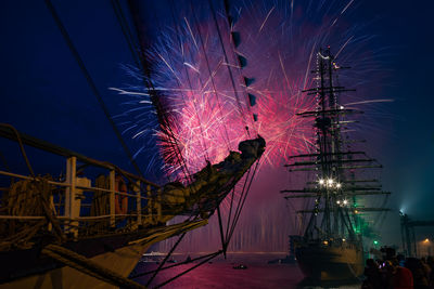 Low angle view of illuminated fireworks against sky at night