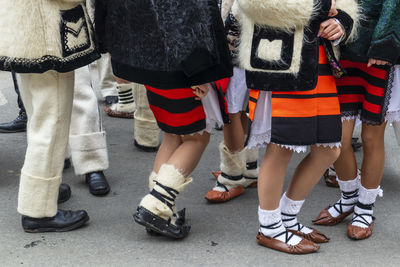 Low section of women standing on street