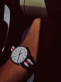 High angle view of hand on clock