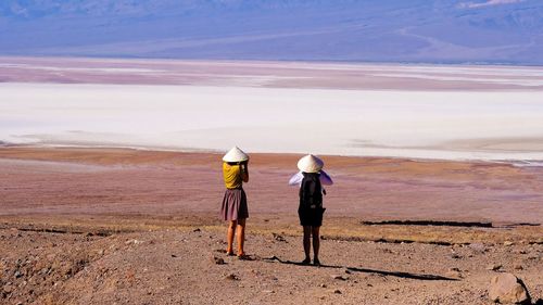 Rear view of photographing in desert