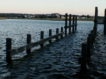 Pier over sea against sky during sunset