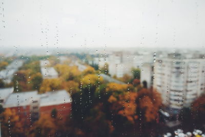 Buildings seen through wet window during rainy season