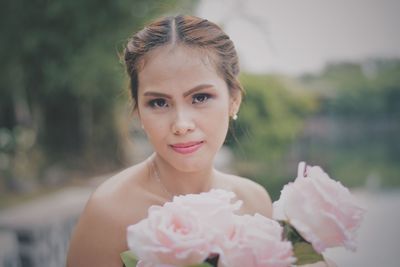 Close-up portrait of happy woman with flowers