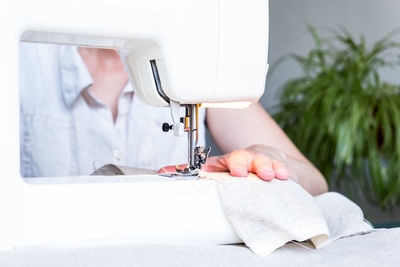 Cropped hand of sewing machine