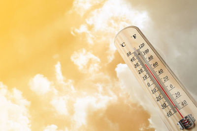 Close-up of information sign against sky