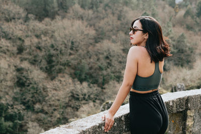 Young woman standing on rock