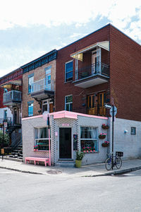 Houses by street against sky in city
