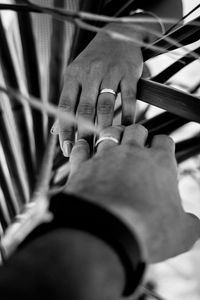 Close-up of man holding hands on table