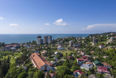 Panoramic view of buildings and sea against sky