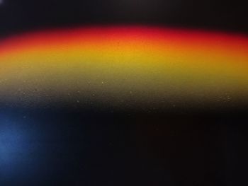 Close-up of illuminated water against sky at night