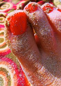 Close-up of hand holding strawberry