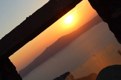 Scenic view of silhouette mountains against sky during sunset