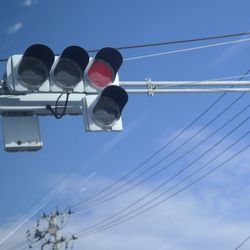 Low angle view of cables against blue sky