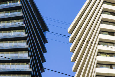 Low angle view of buildings against clear blue sky