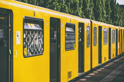 Yellow train at railroad station platform