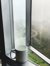 Close-up of coffee cup on window