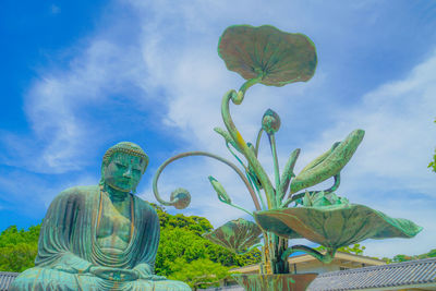 Low angle view of statue against sky