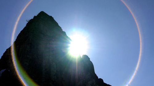 Low angle view of sun shining in sky