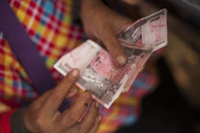 Close-up of hand holding paper currency