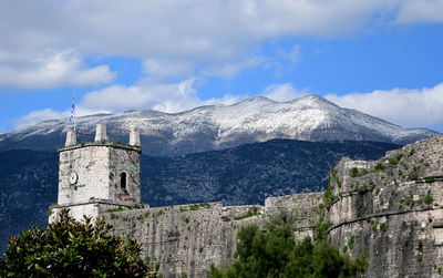 Historic building by mountains against sky