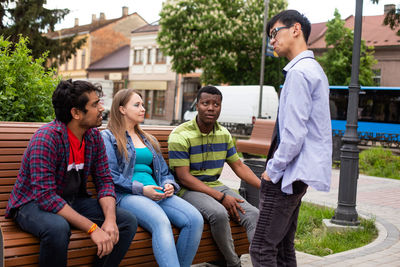 Friends sitting on street