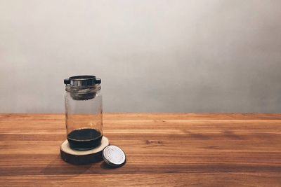 View of coin on table against wall