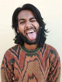 Portrait of smiling young man against white background