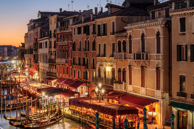 High angle view of illuminated buildings in city at dusk