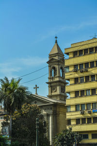 Low angle view of clock tower against sky