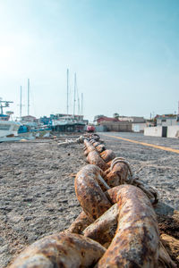 Boats moored on shore against sky