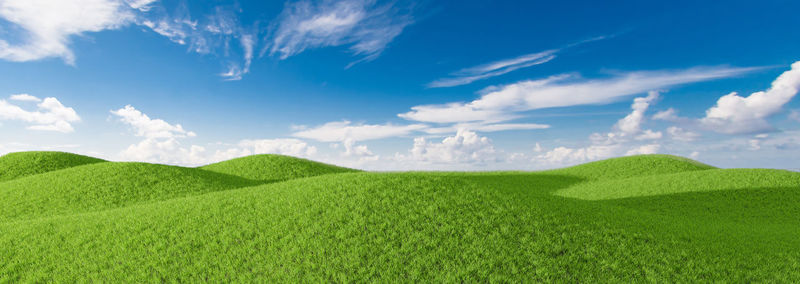 Panoramic view of agricultural field against sky