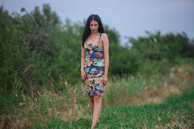 Portrait of woman standing on field