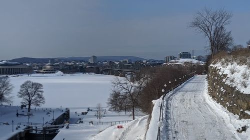 Snow covered buildings against sky