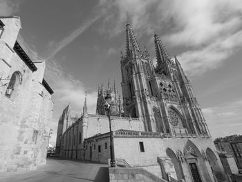 Black and white photo of the façade of the gothic cathedral in burgos, spain. sunny day with beautif