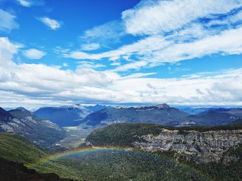 Hiking cerro tronador above a rainbow towards a glacier overlooking a valley