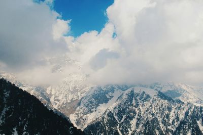 Scenic view of snow covered mountains against sky