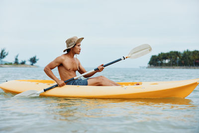 Portrait of woman kayaking in sea