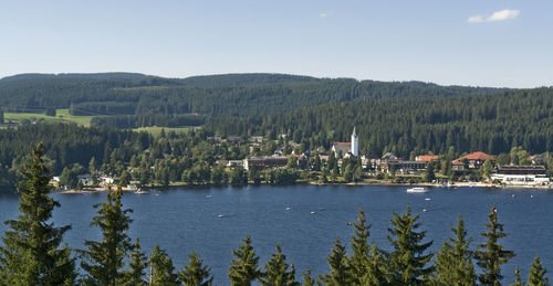 Scenic view of lake by buildings against sky