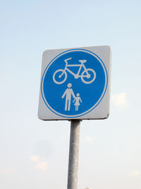 Low angle view of road sign against sky