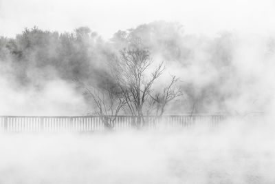 Scenic view of lake against sky during foggy weather