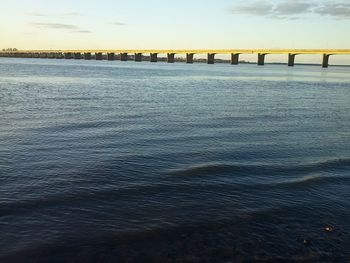 Bridge over sea against sky