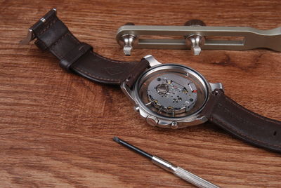 High angle view of wristwatch on table