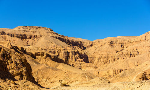 Scenic view of mountains against clear blue sky