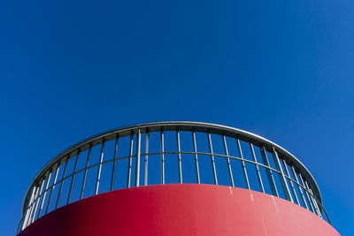 Low angle view of factory against clear blue sky