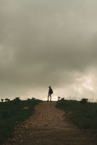 Man standing on field against sky