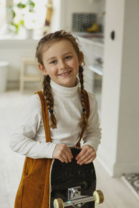 Girl holding skateboard