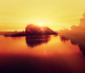 Scenic view of lake at sunset