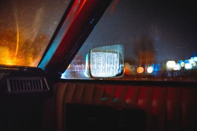 Car in illuminated city at night