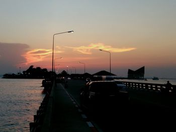 Boats in river at sunset