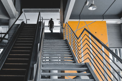 Low angle view of people on escalator